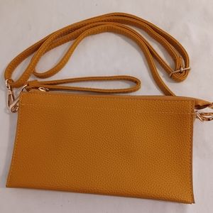 Clutch purse with wrist strap and crossbody strap.  non leather